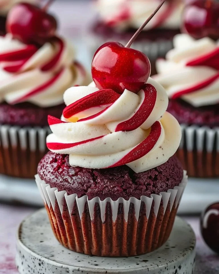 Cherry Red Velvet Cupcakes topped with cream cheese frosting
