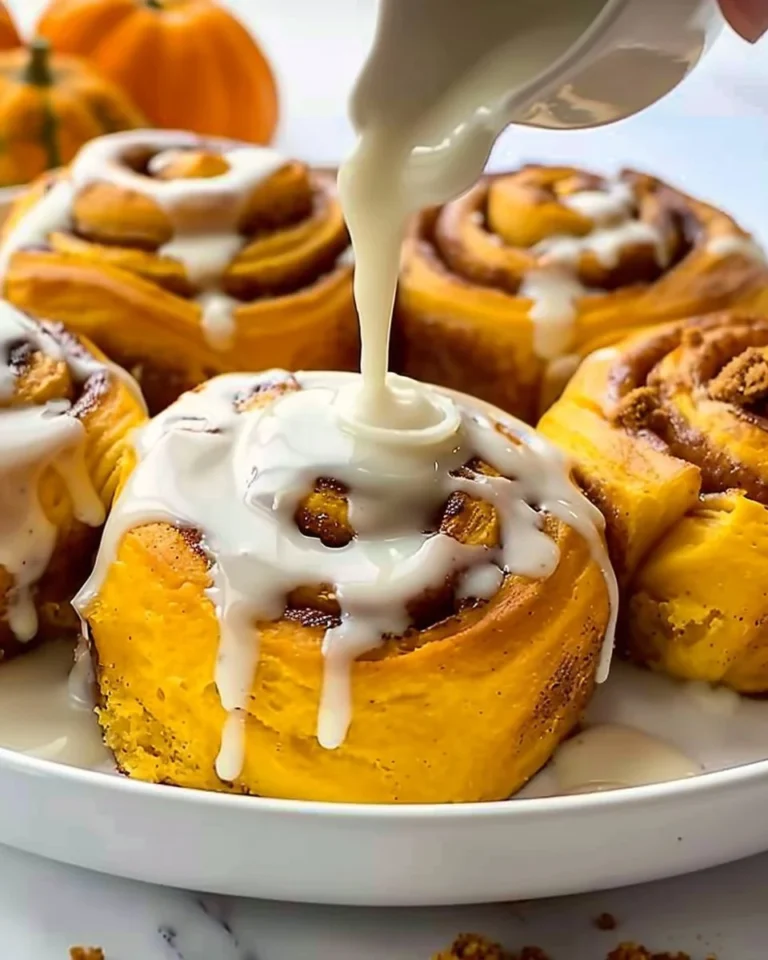 Delicious Pumpkin Cinnamon Rolls topped with cream cheese frosting